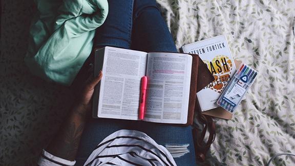 open book with a highlighter laying on it